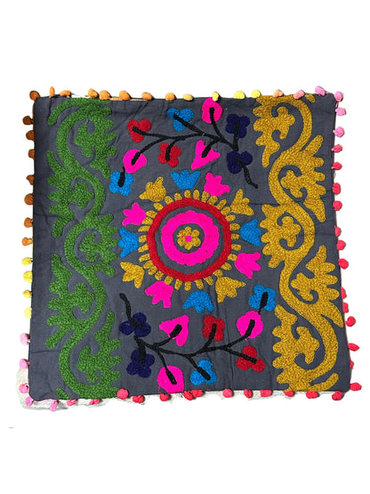 Decorative pillow with colorful embroidery on a plain background