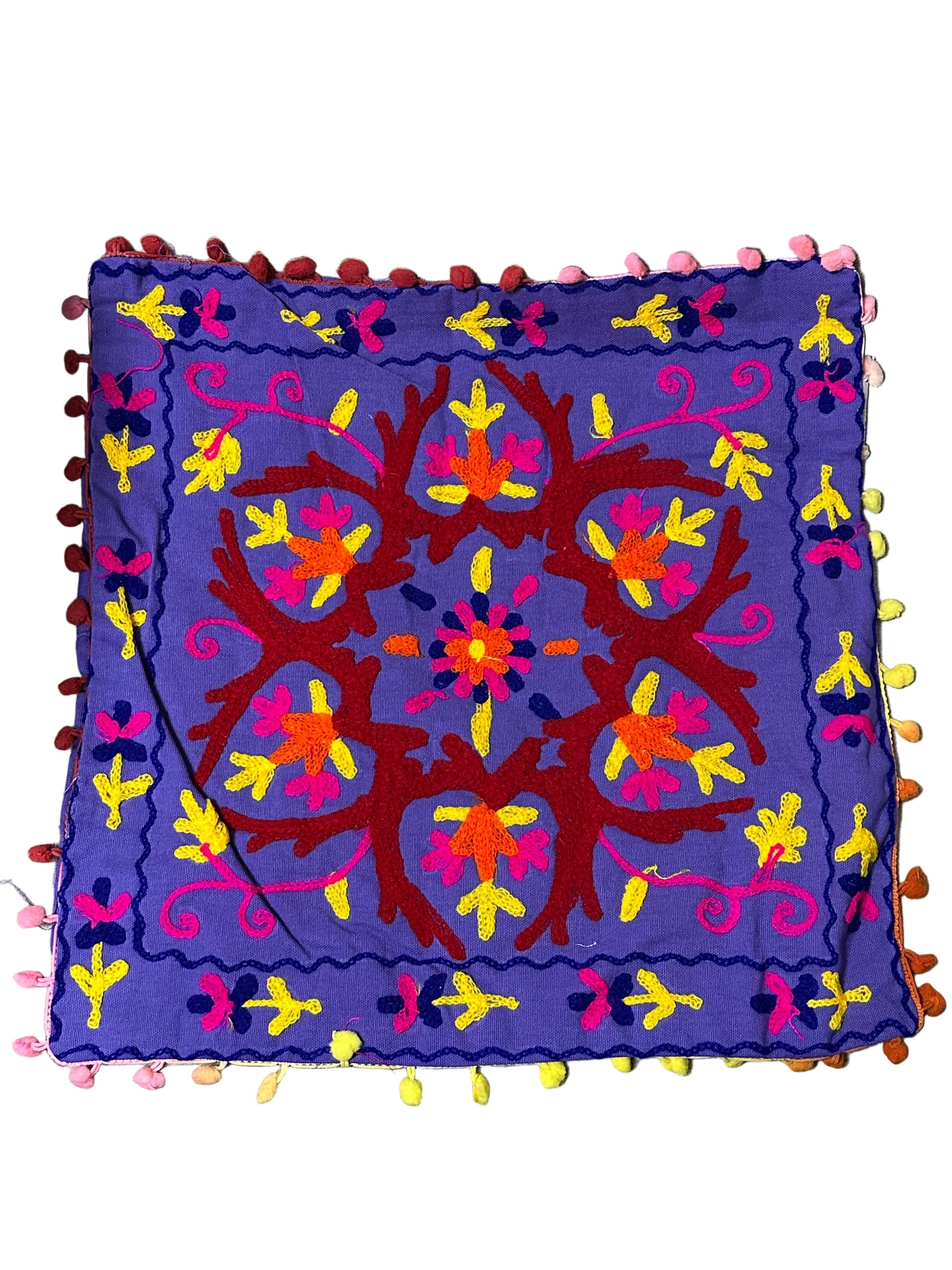Colorful embroidered fabric with intricate patterns on a white background