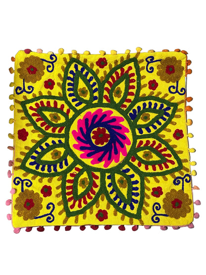 Decorative pillow with a colorful floral pattern on a plain background