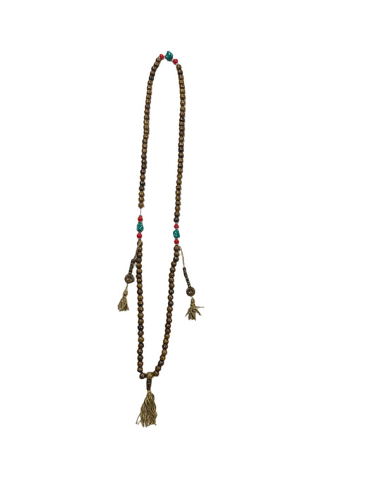 Wooden beaded necklace on a white sheet of paper with packaging in the background.