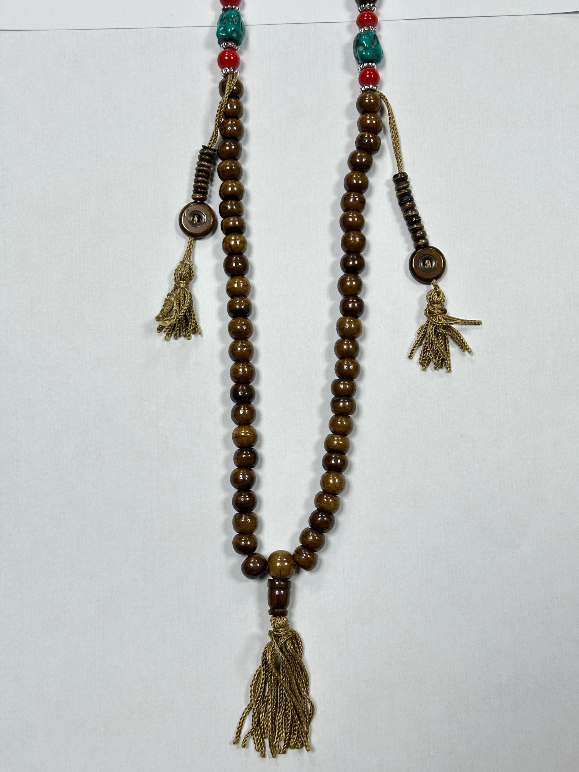 Beaded necklace with tassels on a white background