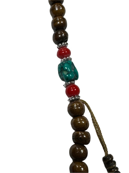 Beaded necklace with brown, red, and green beads on a white background