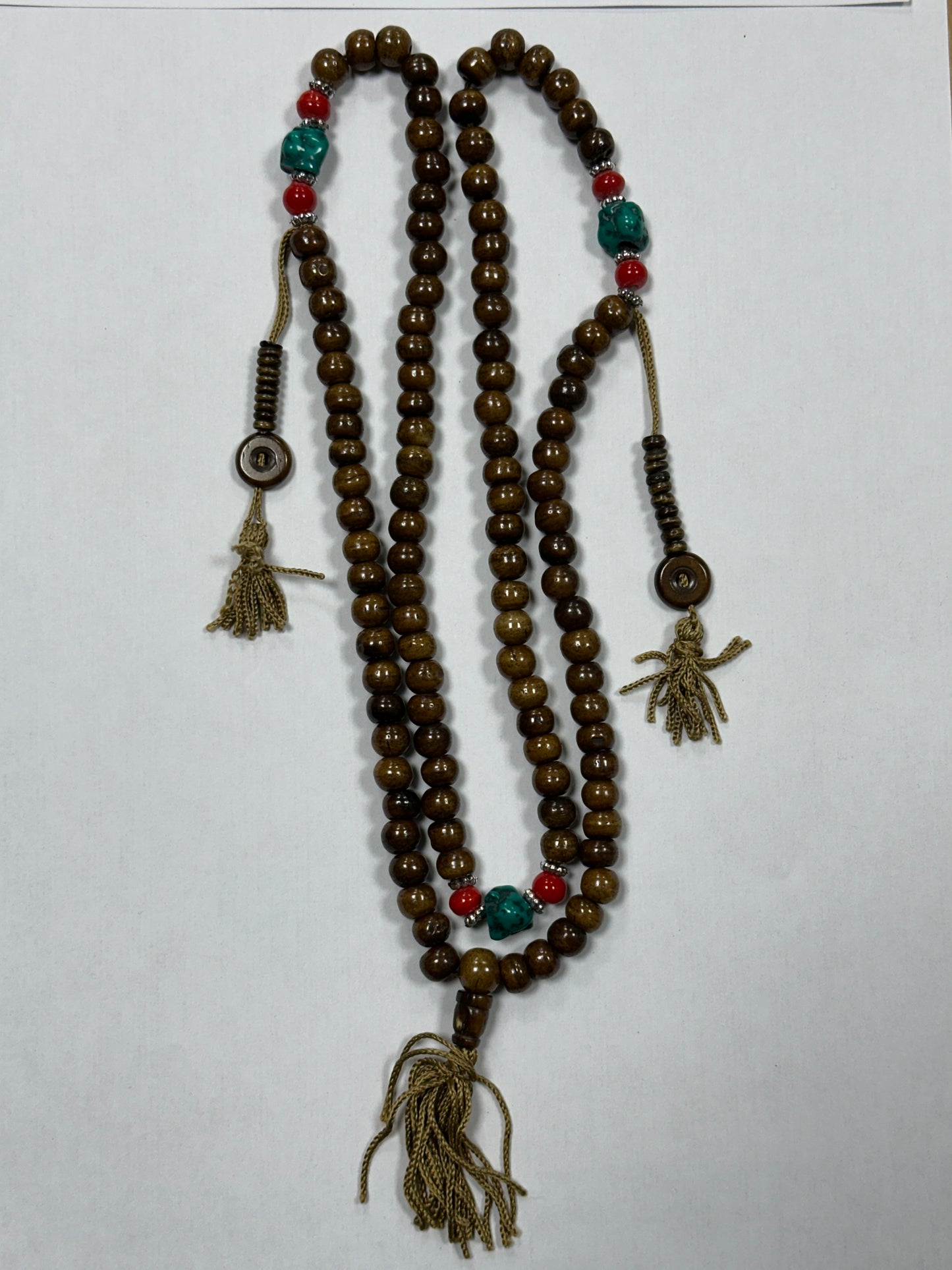 Beaded necklace with tassels on a white background