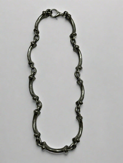 Silver chain on a light gray background