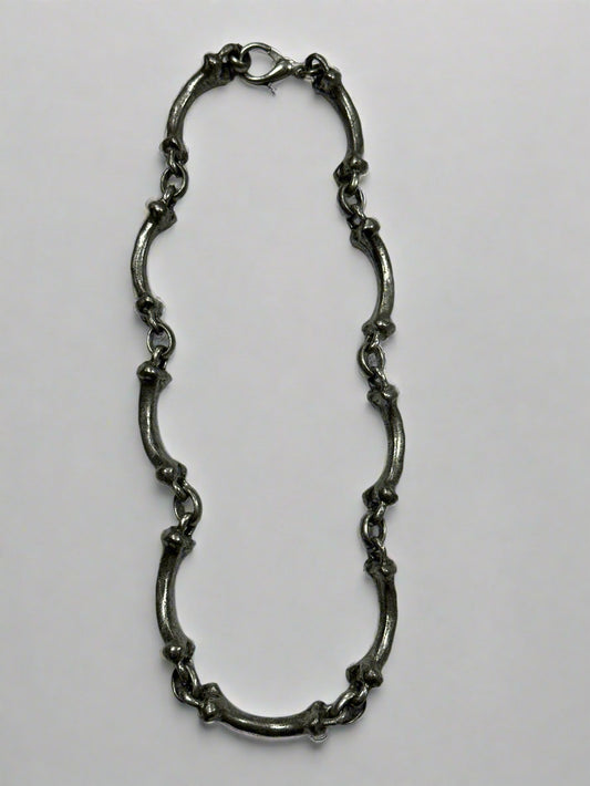 Silver chain on a light gray background