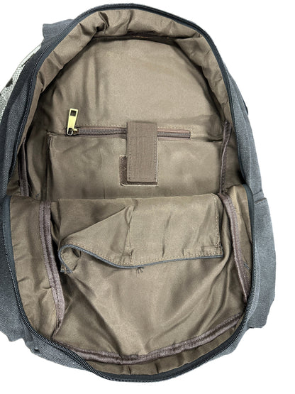 Open backpack showing interior with a patch on a textured surface