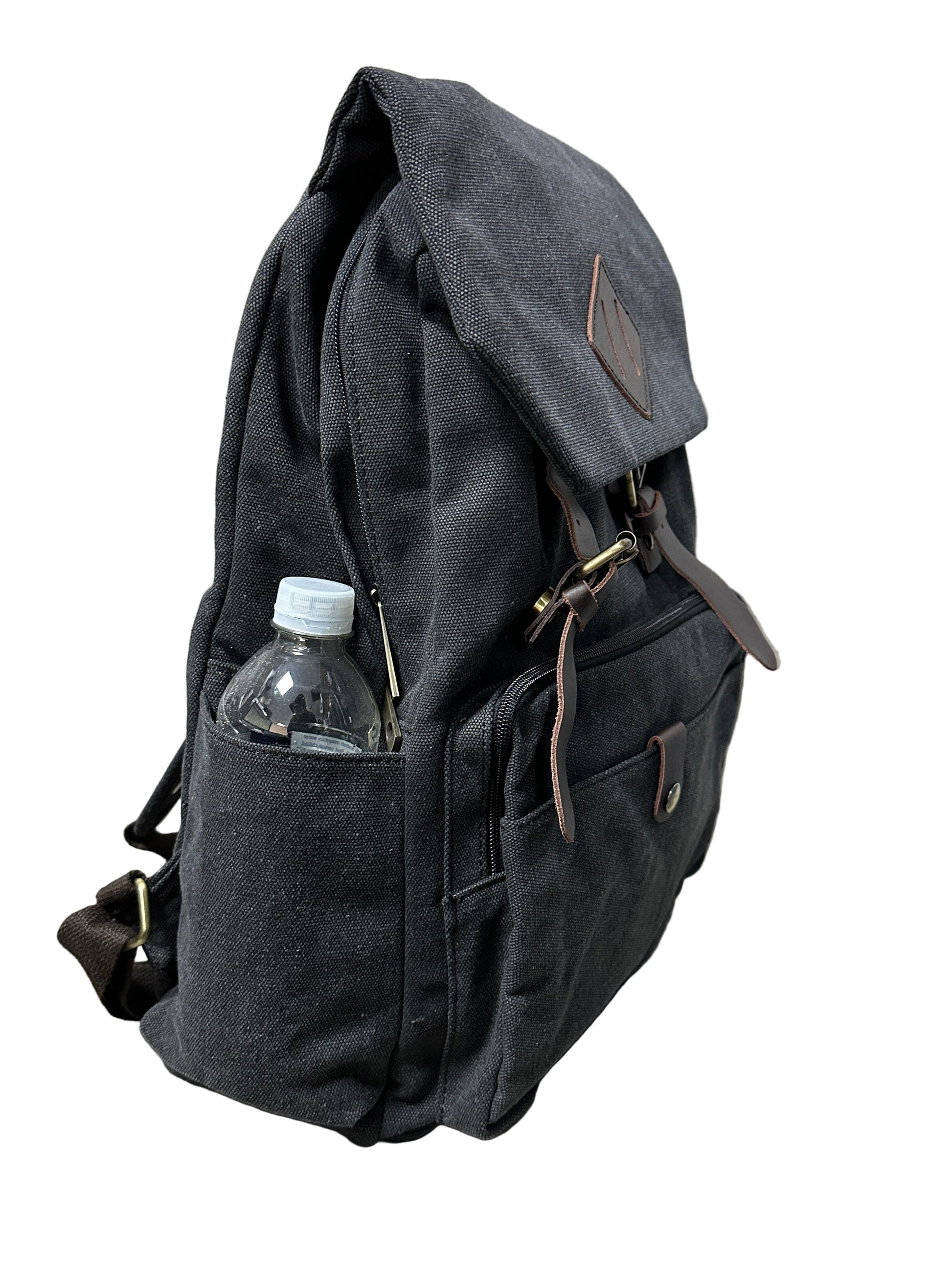 Black backpack with a water bottle inside on a beige surface